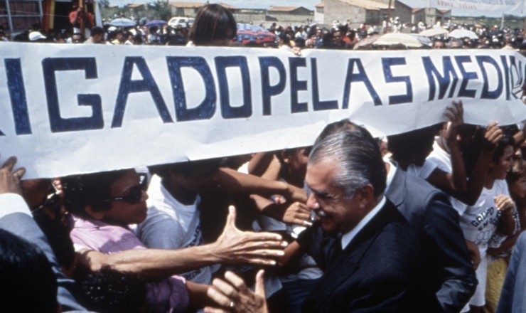   <strong> O presidente Sarney é saudado por populares</strong> devido ao Plano Cruzado, que, entre outras medidas, estabeleceu o congelamento de preços, aumentando o poder de compra dos assalariados